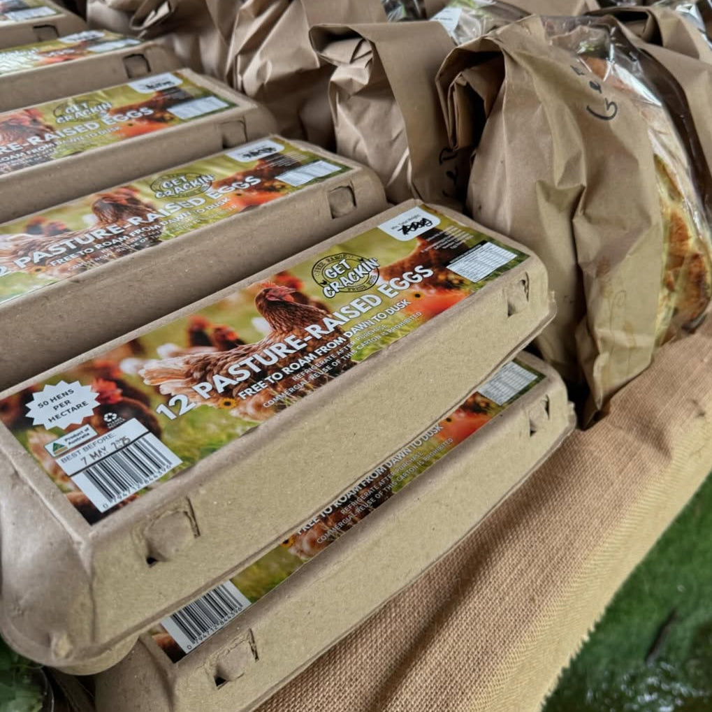 Cartons of eggs with 'Pasture Raised' label on a table
