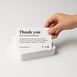 A minimalist product photo featuring a hand gently holding a stack of rounded-edge A6 thank-you postcards. The top card reads “thank you for your order”. The cards have a clean white background, black modern text, and soft lighting, creating an elegant and professional aesthetic ideal for online store packaging.